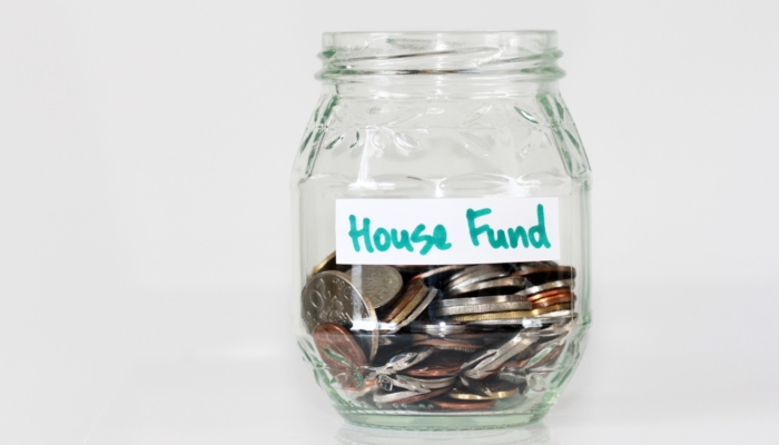 House fund jar with money inside